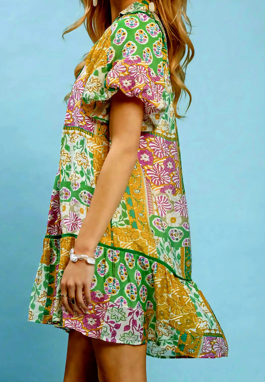 Woman wearing a colorful floral dress against a blue background