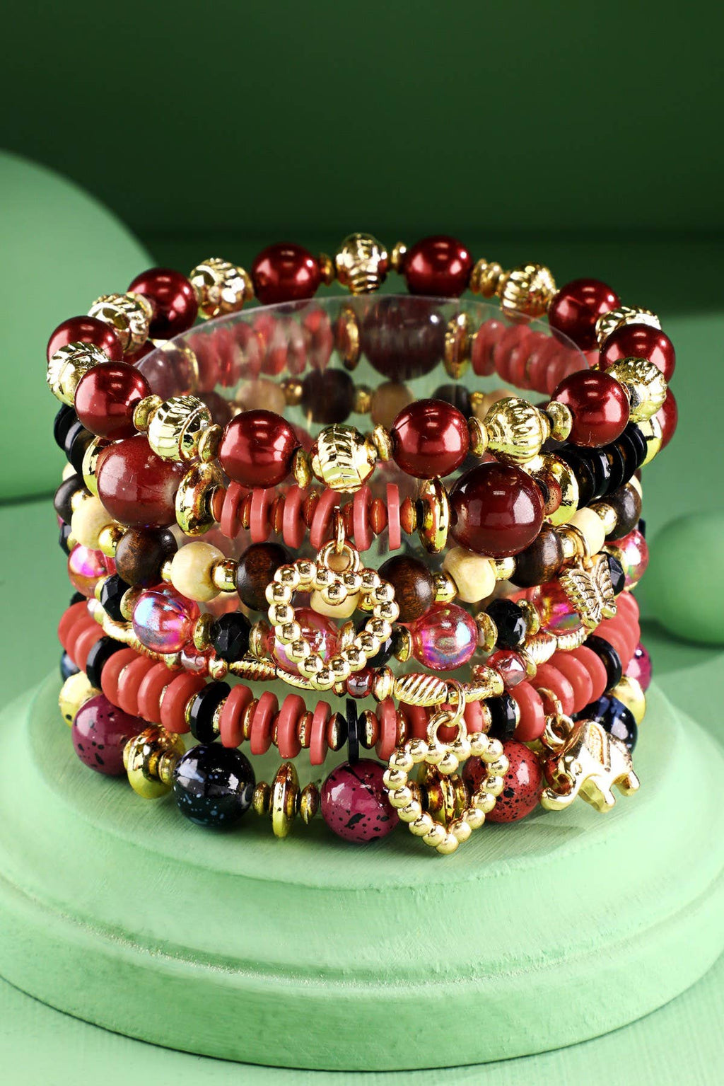 Stack of red multi color beaded bracelets with gold accents 