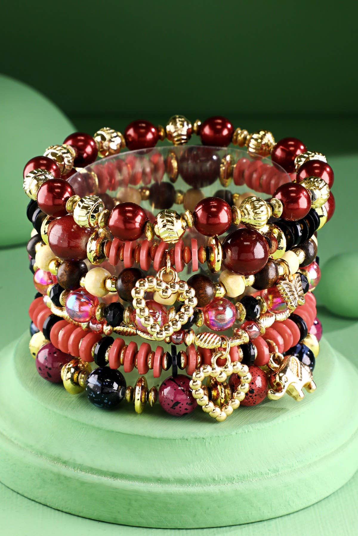 Stack of red multi color beaded bracelets with gold accents 