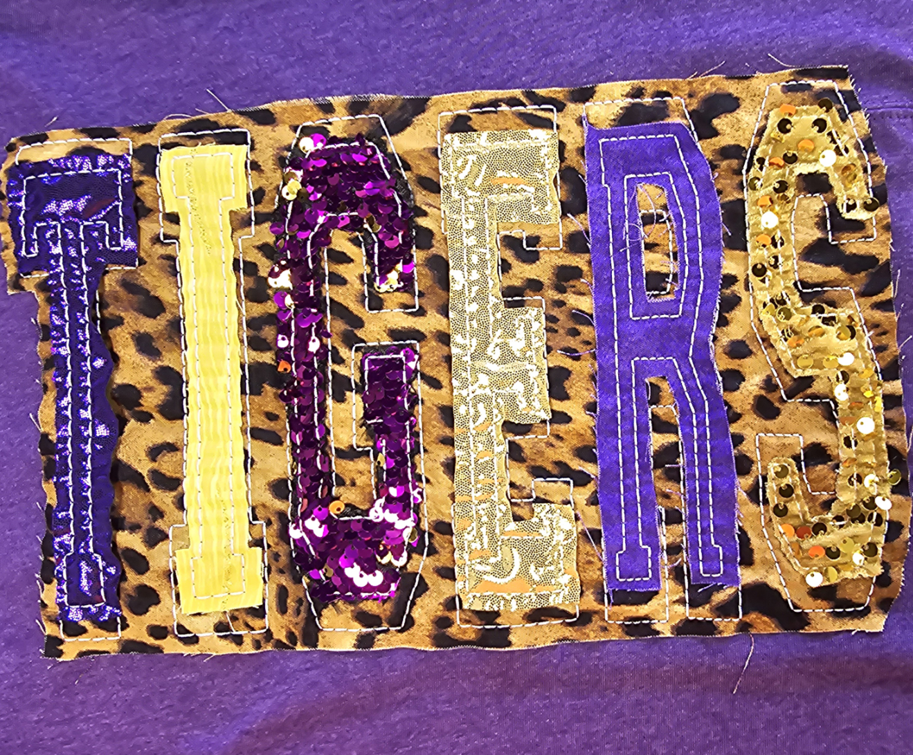 "TIGERS" UNIQUE SEQUIN DOUBLE STACKED LETTERED HEATHERED PURPLE FOOTBALL T-SHIRT | Small - 3X | Charlotte's Classy Closet