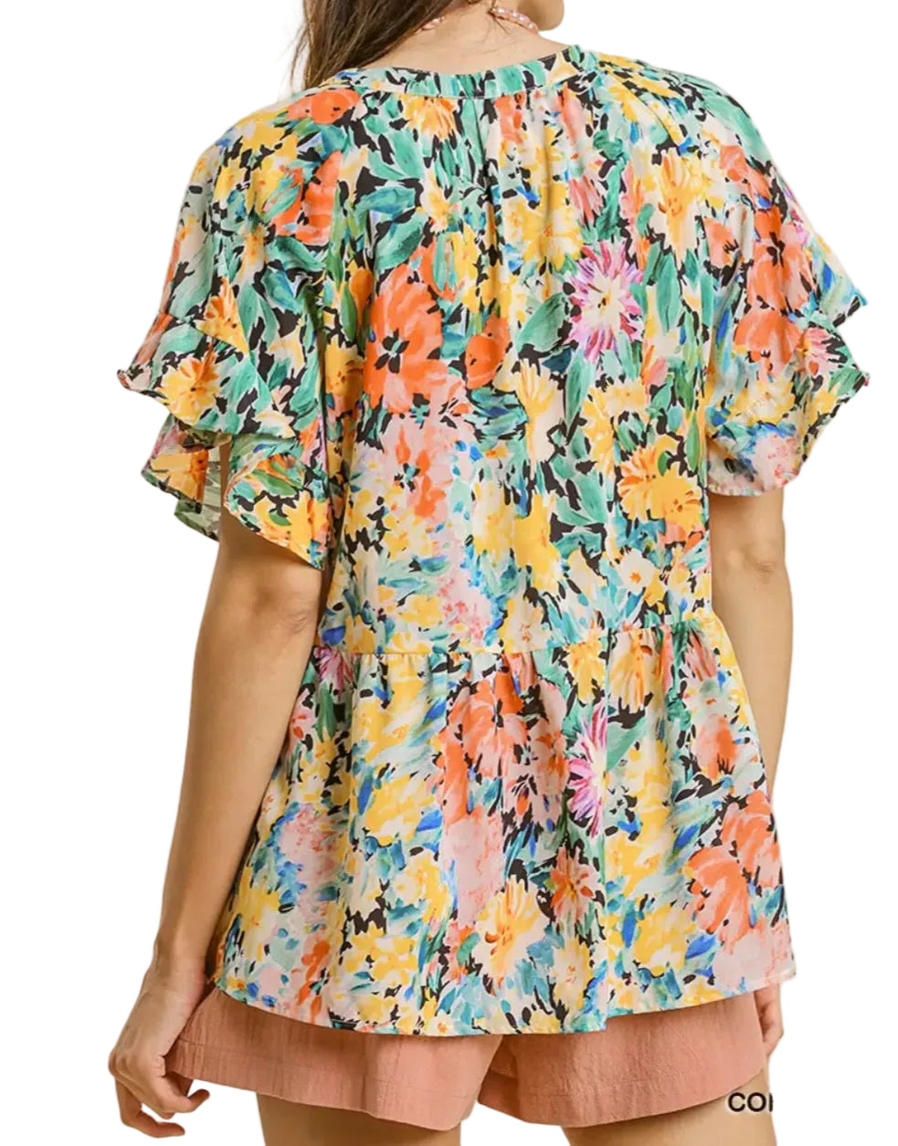 Multicolored floral blouse with ruffled sleeves on a beige background