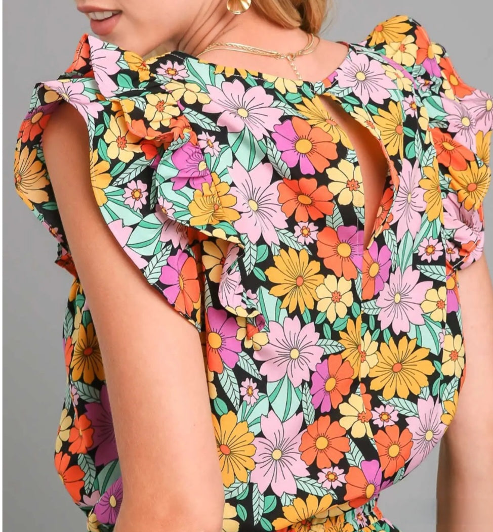 Colorful floral romper with ruffled sleeves on a gray background