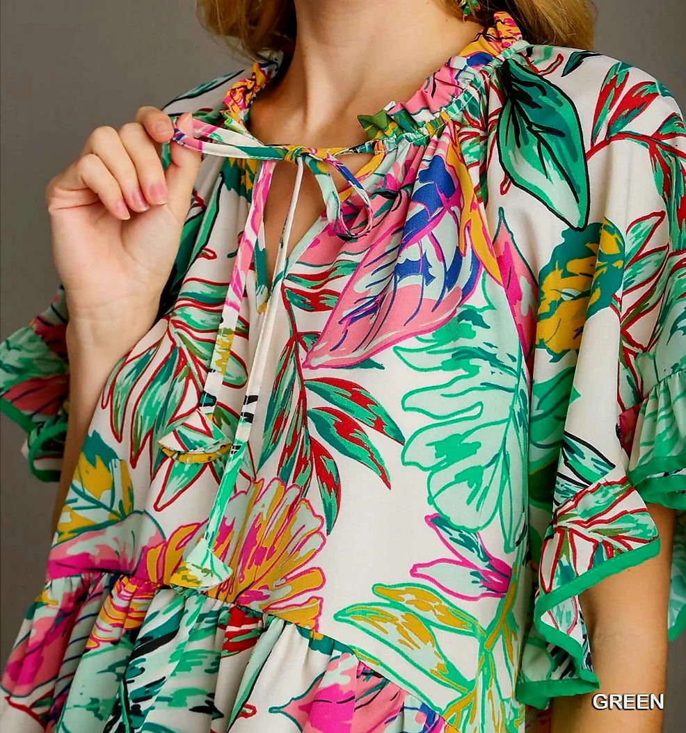 Colorful tropical print dress with a plain background